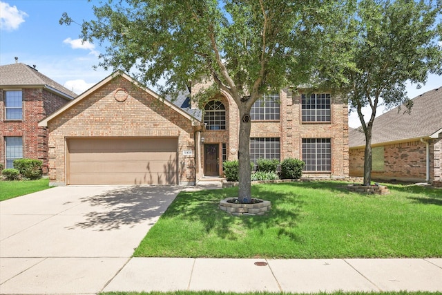 12428 Leaflet Dr, Fort Worth, TX 76244 - traditional home featuring brick siding, a garage, a front yard, and driveway