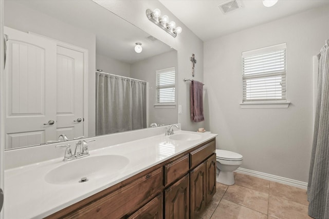 12428 Leaflet Dr, Fort Worth, TX 76244 - bathroom featuring baseboards, double vanity, toilet, curtained shower, and tile patterned floors