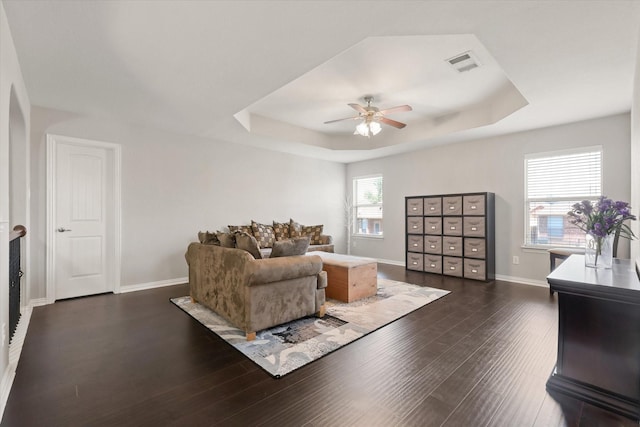 12428 Leaflet Dr, Fort Worth, TX 76244 - living room featuring a tray ceiling, a ceiling fan, dark wood-style floors, and baseboards