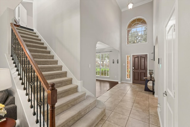 12428 Leaflet Dr, Fort Worth, TX 76244 - foyer entrance featuring crown molding, stairs, healthy amount of natural light, light tile patterned flooring, and a towering ceiling