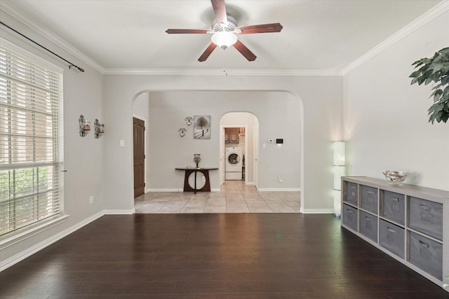 12428 Leaflet Dr, Fort Worth, TX 76244 - empty room with washer / clothes dryer, arched walkways, a ceiling fan, wood finished floors, and ornamental molding