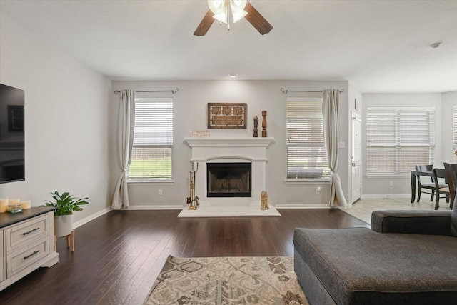 12428 Leaflet Dr, Fort Worth, TX 76244 - living room with a ceiling fan, baseboards, wood finished floors, and a fireplace with raised hearth