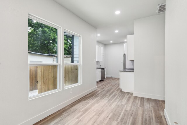 2904 Valentine St, Dallas, TX 75215 - unfurnished living room with light wood finished floors, baseboards, and recessed lighting