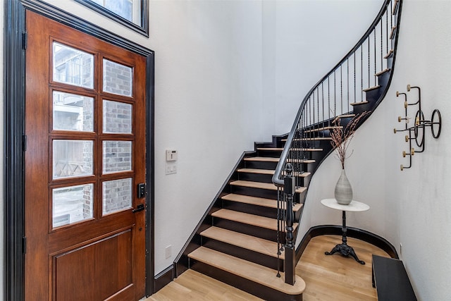 4518 Gilbert Ave, Dallas, TX 75219 - entrance foyer with wood finished floors, stairway, and baseboards