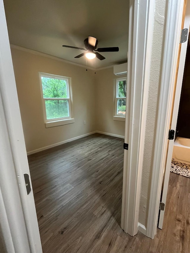 412 Sands Ct, White Settlement, TX 76108 - spare room with crown molding, dark wood-style flooring, a wall unit AC, healthy amount of natural light, and a ceiling fan