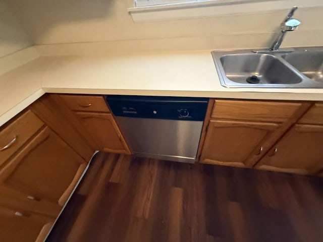 413 Creekwood Ln, Lewisville, TX 75067 - kitchen featuring stainless steel dishwasher, a sink, dark wood finished floors, brown cabinetry, and light countertops