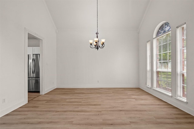 3936 Gillespie Dr, Carrollton, TX 75010 - unfurnished dining area featuring vaulted ceiling, a chandelier, ornamental molding, plenty of natural light, and light wood-type flooring