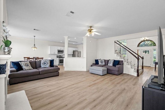 3936 Gillespie Dr, Carrollton, TX 75010 - living area featuring light wood-style flooring, ceiling fan, stairway, decorative columns, and recessed lighting