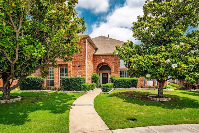 3936 Gillespie Dr, Carrollton, TX 75010 - view of front of home featuring brick siding, a front lawn, and roof with shingles