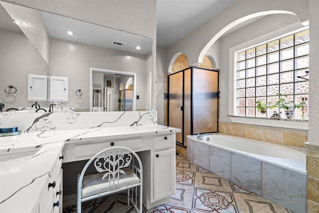 3936 Gillespie Dr, Carrollton, TX 75010 - full bath featuring a garden tub, double vanity, a stall shower, tile patterned flooring, and recessed lighting
