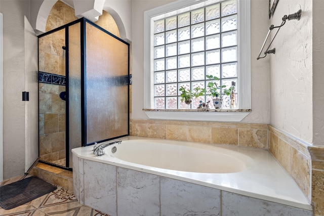 3936 Gillespie Dr, Carrollton, TX 75010 - full bath featuring plenty of natural light, a stall shower, a bath, and a textured wall