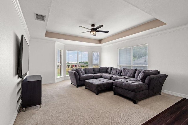 3936 Gillespie Dr, Carrollton, TX 75010 - living room with a raised ceiling, a ceiling fan, baseboards, light wood finished floors, and ornamental molding