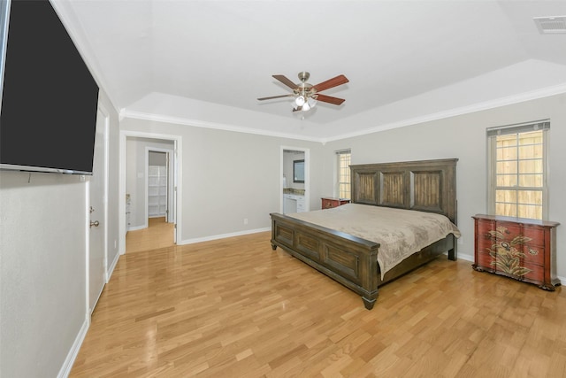 1113 Yorkshire Dr, Carrollton, TX 75007 - bedroom with a tray ceiling, light wood finished floors, baseboards, ornamental molding, and a ceiling fan