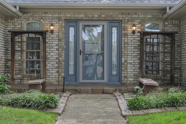 1113 Yorkshire Dr, Carrollton, TX 75007 - view of exterior entry with brick siding and a shingled roof