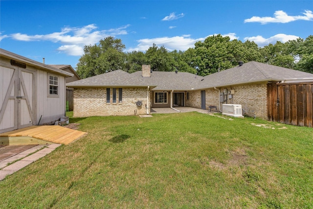 1113 Yorkshire Dr, Carrollton, TX 75007 - rear view of property featuring brick siding, a chimney, a patio area, and roof with shingles