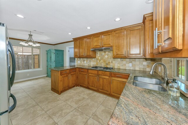 1113 Yorkshire Dr, Carrollton, TX 75007 - kitchen with appliances with stainless steel finishes, a sink, brown cabinetry, under cabinet range hood, and recessed lighting