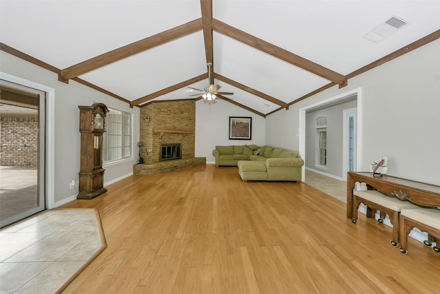 1113 Yorkshire Dr, Carrollton, TX 75007 - living room with light wood finished floors, ceiling fan, baseboards, and a fireplace