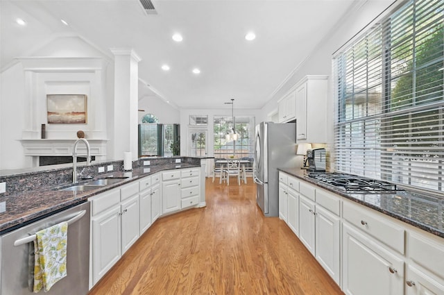 1403 Chelsea Cir, Southlake, TX 76092 - kitchen with appliances with stainless steel finishes, a sink, white cabinets, light wood-style floors, and recessed lighting