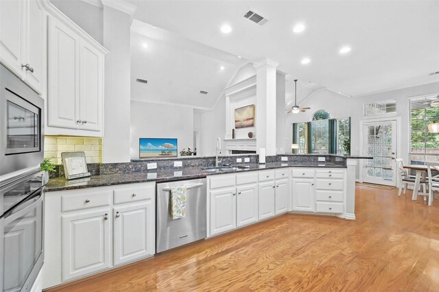 1403 Chelsea Cir, Southlake, TX 76092 - kitchen with appliances with stainless steel finishes, a sink, lofted ceiling, white cabinets, and a ceiling fan