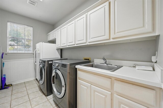1403 Chelsea Cir, Southlake, TX 76092 - washroom with cabinet space, washing machine and clothes dryer, and light tile patterned flooring