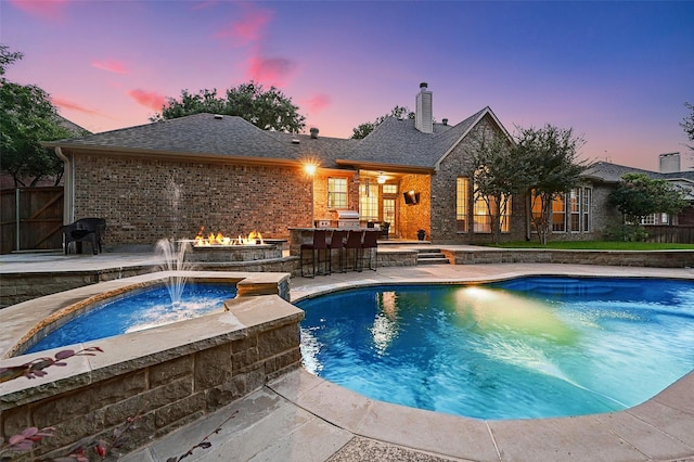 1403 Chelsea Cir, Southlake, TX 76092 - pool at dusk featuring grilling area and a patio