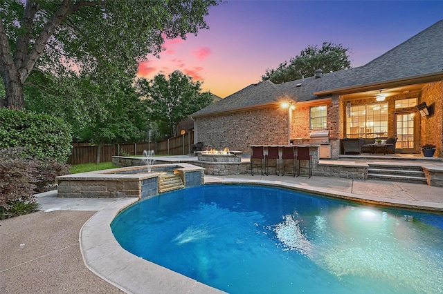 1403 Chelsea Cir, Southlake, TX 76092 - pool at dusk featuring a fire pit, a patio area, and a pool with connected hot tub