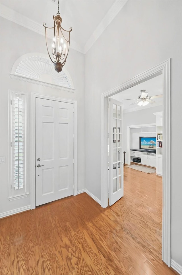 1403 Chelsea Cir, Southlake, TX 76092 - foyer with a chandelier, crown molding, light wood finished floors, baseboards, and ceiling fan