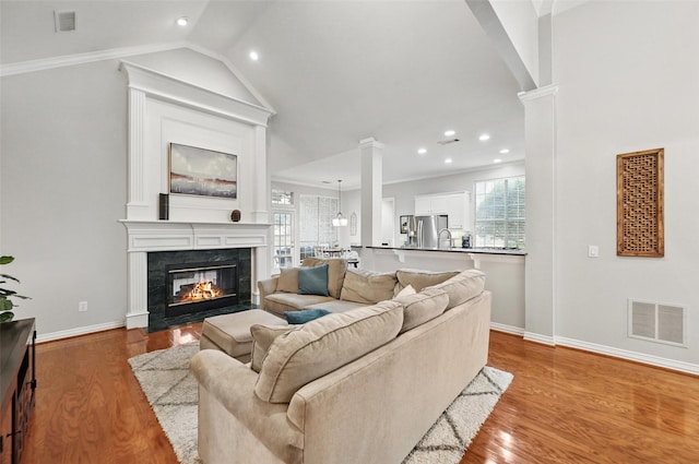 1403 Chelsea Cir, Southlake, TX 76092 - living area with ornate columns, baseboards, wood finished floors, vaulted ceiling, and recessed lighting