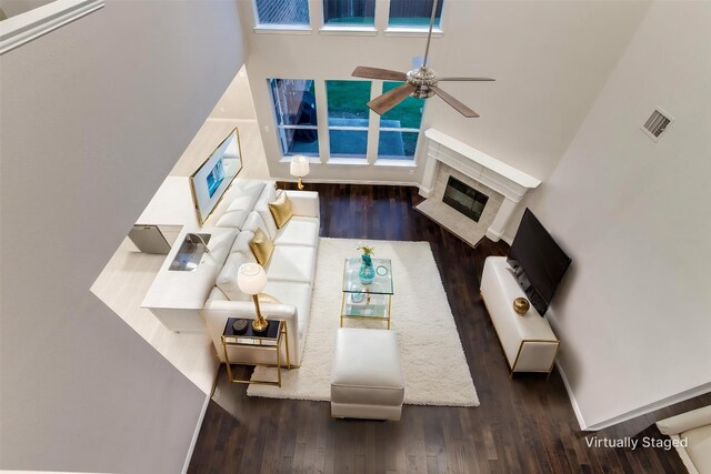 14548 Blakehill Dr, Frisco, TX 75035 - living room featuring a ceiling fan, a glass covered fireplace, wood finished floors, and baseboards