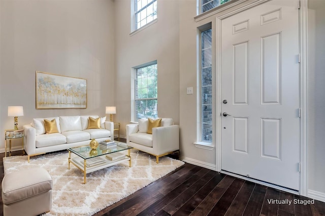 14548 Blakehill Dr, Frisco, TX 75035 - living area with dark wood-style flooring, baseboards, plenty of natural light, and a high ceiling