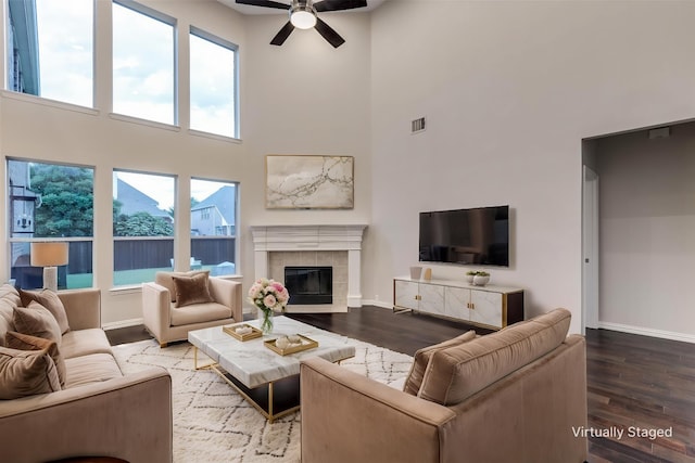 14548 Blakehill Dr, Frisco, TX 75035 - living room with a high ceiling, ceiling fan, baseboards, wood finished floors, and healthy amount of natural light