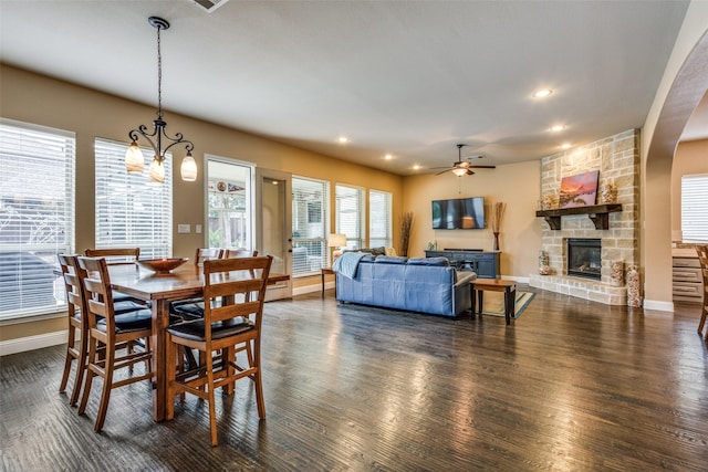 5014 Toledo Bend Dr, Frisco, TX 75033 - dining room featuring a stone fireplace, ceiling fan, dark wood finished floors, and recessed lighting