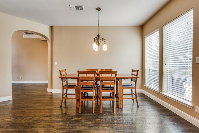 5014 Toledo Bend Dr, Frisco, TX 75033 - dining area featuring arched walkways, dark wood-style floors, and healthy amount of natural light