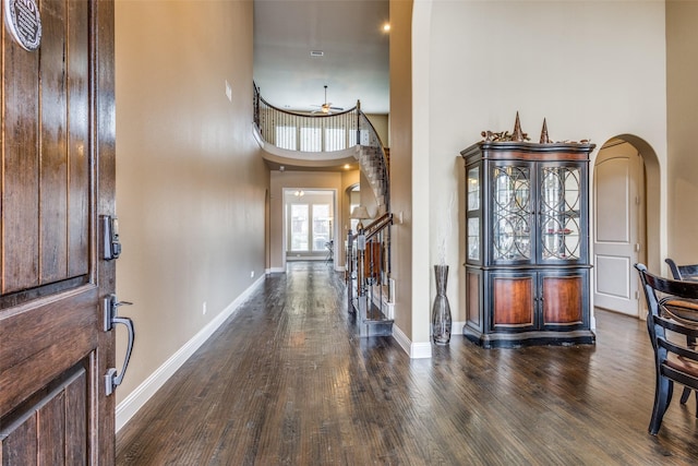 5014 Toledo Bend Dr, Frisco, TX 75033 - foyer with arched walkways, a towering ceiling, and wood finished floors