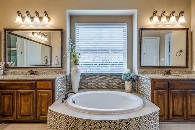 5014 Toledo Bend Dr, Frisco, TX 75033 - bathroom with a garden tub, two vanities, and tile patterned floors