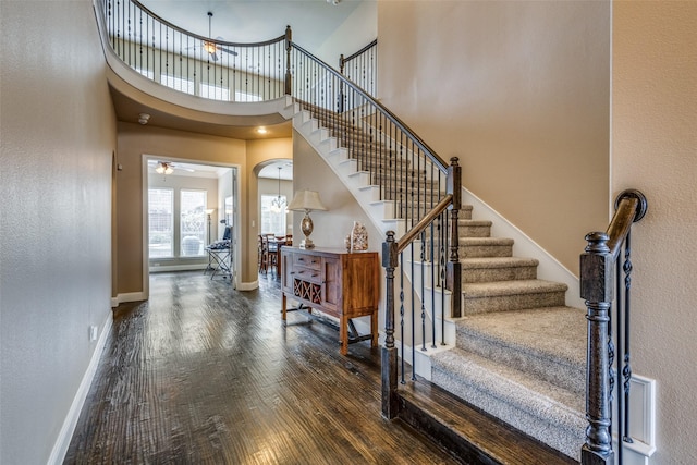 5014 Toledo Bend Dr, Frisco, TX 75033 - foyer entrance with wood finished floors, stairs, a ceiling fan, a towering ceiling, and arched walkways