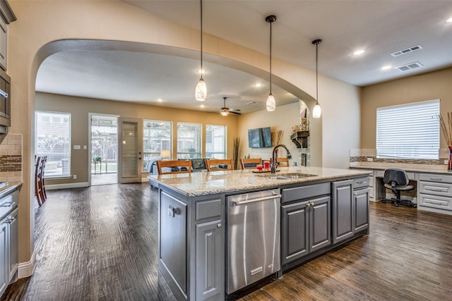 5014 Toledo Bend Dr, Frisco, TX 75033 - kitchen featuring stainless steel dishwasher, arched walkways, gray cabinets, dark wood-type flooring, and recessed lighting