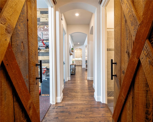 2624 Seabiscuit Rd, Celina, TX 75009 - hall featuring dark wood finished floors, arched walkways, and baseboards