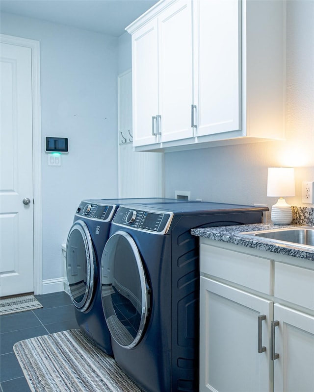 2624 Seabiscuit Rd, Celina, TX 75009 - laundry room featuring cabinet space, washing machine and clothes dryer, and dark tile patterned floors