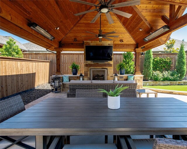 2624 Seabiscuit Rd, Celina, TX 75009 - fenced backyard featuring a fireplace, a gazebo, ceiling fan, and outdoor dining space