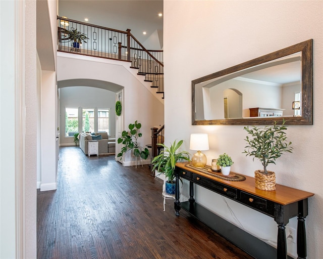 2624 Seabiscuit Rd, Celina, TX 75009 - hallway with arched walkways, wood finished floors, baseboards, stairs, and recessed lighting