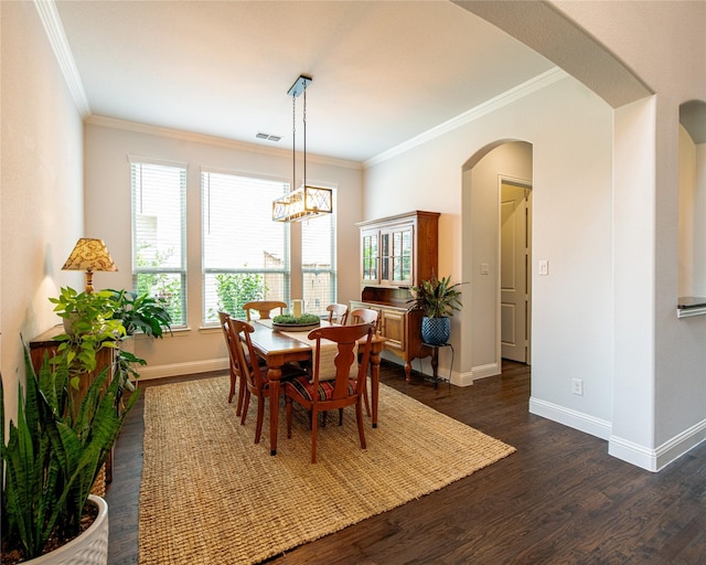 2624 Seabiscuit Rd, Celina, TX 75009 - dining room with dark wood-type flooring, arched walkways, crown molding, and baseboards