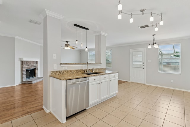 1812 Elk Lake Trl, Justin, TX 76247 - kitchen featuring stainless steel dishwasher, a sink, light tile patterned flooring, crown molding, and ceiling fan