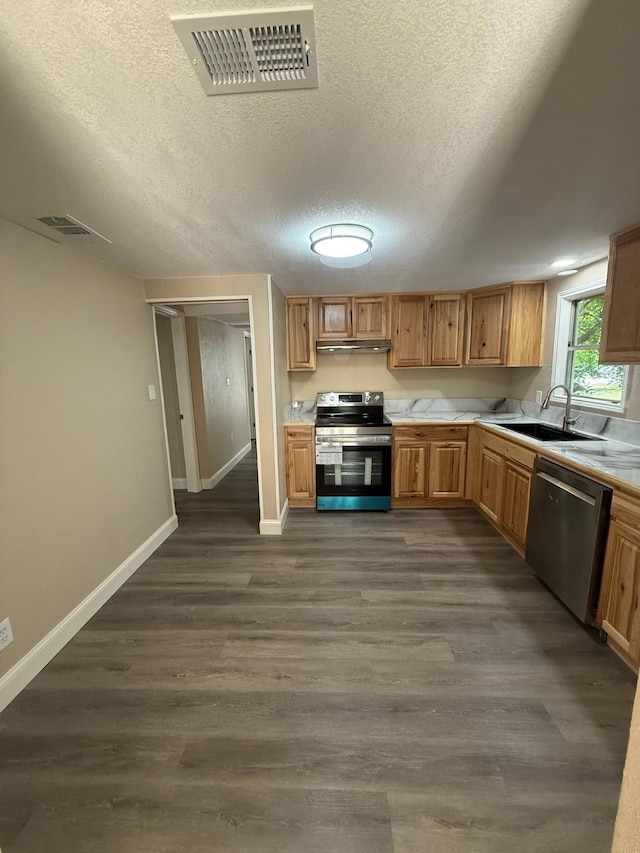 602 Pierson St, Lancaster, TX 75146 - kitchen featuring appliances with stainless steel finishes, a sink, dark wood finished floors, light countertops, and baseboards