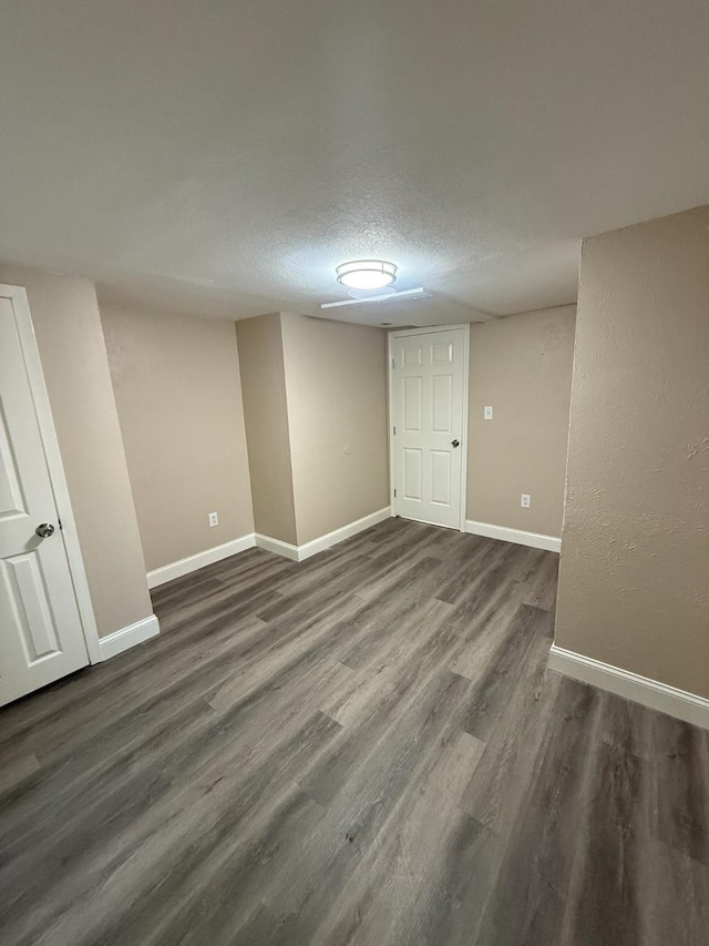 602 Pierson St, Lancaster, TX 75146 - unfurnished room featuring dark wood-style floors, baseboards, and a textured ceiling
