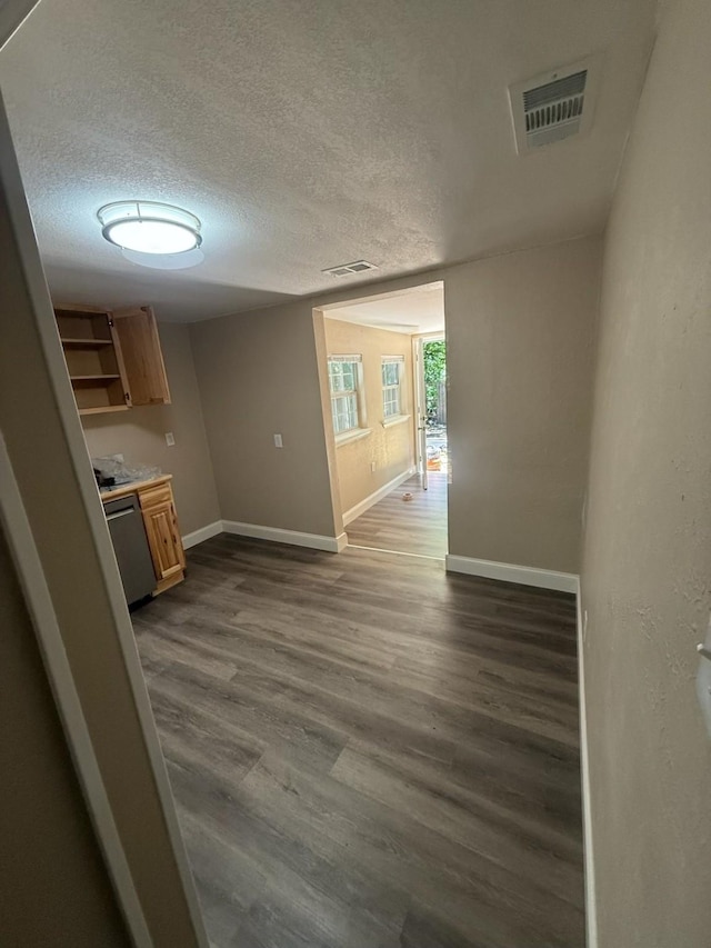 602 Pierson St, Lancaster, TX 75146 - hall with a textured ceiling, dark wood-style floors, and baseboards