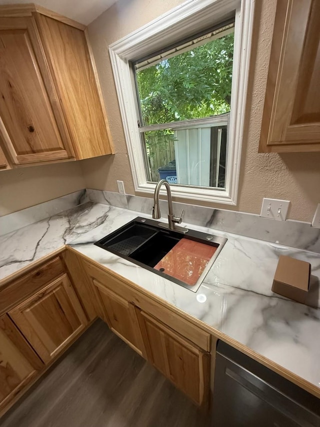 602 Pierson St, Lancaster, TX 75146 - kitchen with a sink, dark wood-style flooring, a textured wall, dishwasher, and light stone countertops