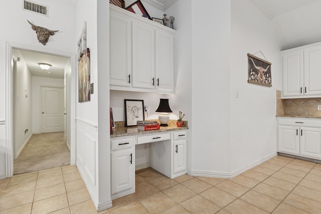 816 Claycourt Cir, Fort Worth, TX 76120 - kitchen featuring light tile patterned flooring, tasteful backsplash, light stone countertops, white cabinets, and ornamental molding