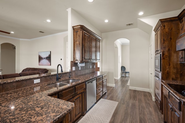 14208 Lucille Dr, Newark, TX 76071 - kitchen with stainless steel appliances, a sink, arched walkways, dark stone countertops, and recessed lighting
