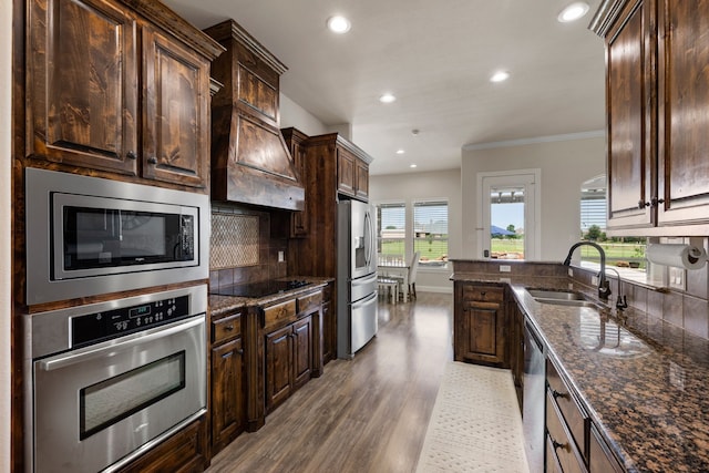 14208 Lucille Dr, Newark, TX 76071 - kitchen featuring stainless steel appliances, a sink, dark brown cabinetry, recessed lighting, and ornamental molding